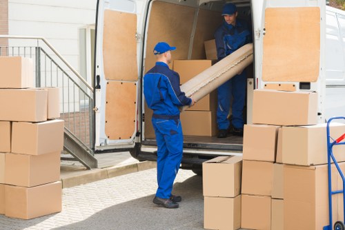 Movers handling items safely during a Holland Park removal