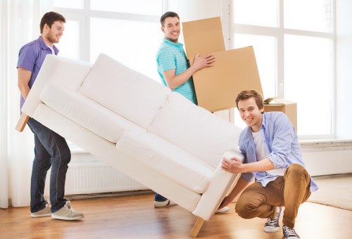 Professional removal crew assisting with residential flat moving in Holland Park