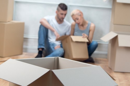 Professional movers loading household items into a removal van in West London