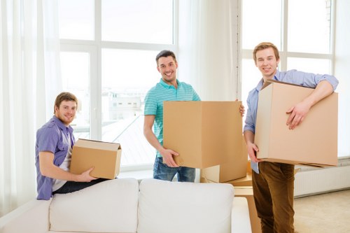 Delivered furniture being placed carefully in a Holland Park apartment