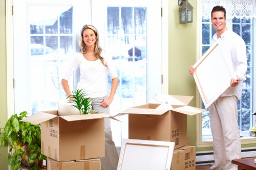 Packed moving boxes and furniture prepared for a Holland Park relocation