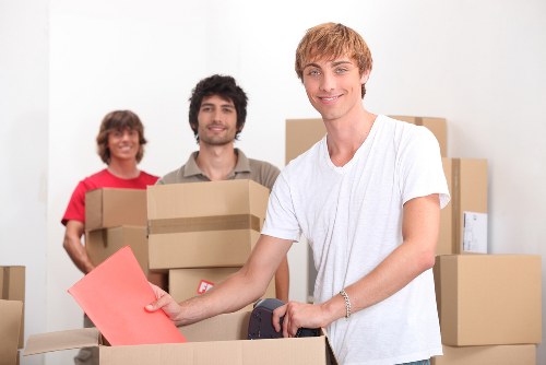 Professional movers handling furniture in a London street